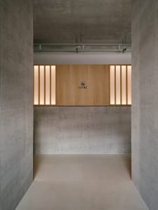 Modern interior space with concrete walls and wooden elements.