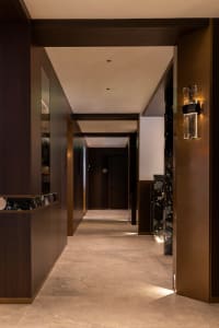 Modern hotel hallway with marble, wood, concrete flooring and ceiling lights