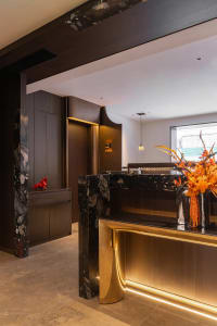 Modern office reception desk featuring marble and metal materials.