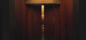 A wooden doorway with a light-colored interior.