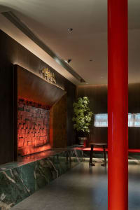A modern restaurant interior featuring metal, wood, and marble elements.