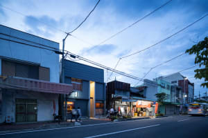 Concrete and plaster urban street scene with electrical wires and buildings.