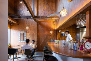 Interior view of an industrial-themed restaurant featuring wooden walls and furniture.