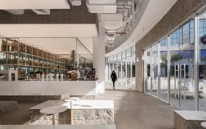 Modern cafe with marble, glass, metal, and concrete interior design.