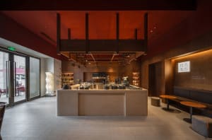 A modern coffee shop with a minimalist interior featuring wood and marble materials.