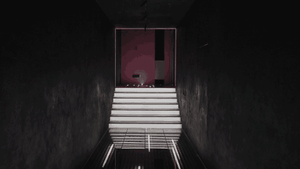 A modern interior design featuring a white staircase and a red door.