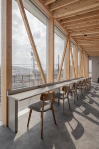 Minimalist interior design featuring concrete and wood materials in a public library setting.