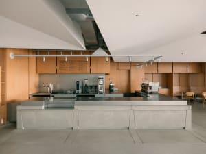 Minimalist coffee shop interior with concrete flooring and minimalist design elements.