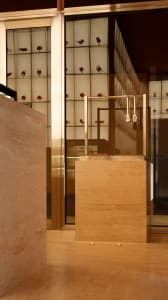 A modern retail shop interior with a striking sandstone reception counter and sleek furnishings.