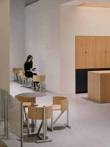 A modern minimalist restaurant with wooden furniture and seating