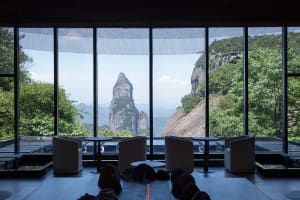 Hotel lobby with glass windows overlooking natural scenery and mountains