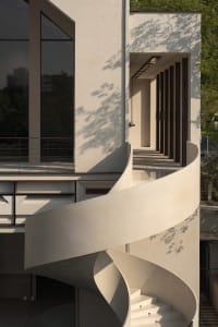 Concrete staircase leading to a modern architectural design.