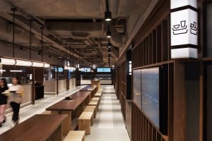 Industrial-themed restaurant interior with wooden tables and minimalist design