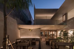 An image of a modern restaurant interior featuring concrete and wood materials.