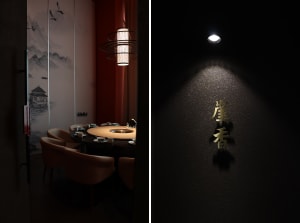 Modern restaurant interior featuring wooden table with a lamp hanging above it.