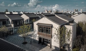 A street view image featuring buildings made of concrete, glass, and tile.