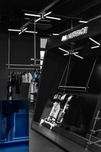 A modern retail store interior featuring glass and metal elements.