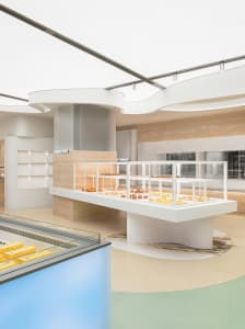 A modern bakery interior with light-colored marble countertops and concrete elements.