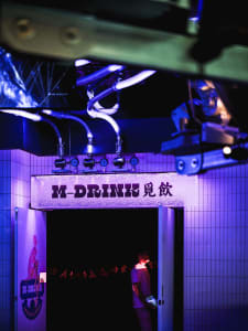 Metallic storefront in a dimly lit urban alleyway with industrial design elements.