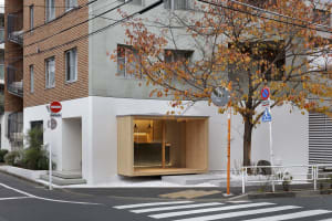 A modern exterior building with wooden accents and a concrete structure.