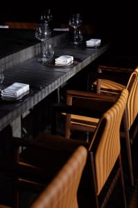 Dining room with concrete and leather elements in a modern restaurant setting.