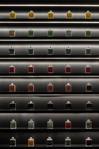 A row of metallic bottles arranged on multiple shelves.