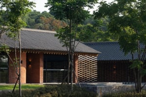 A modern building exterior made of brick, concrete, and wood.
