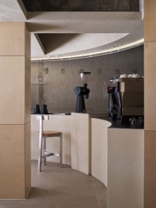 A minimalist coffee bar with a concrete surface.