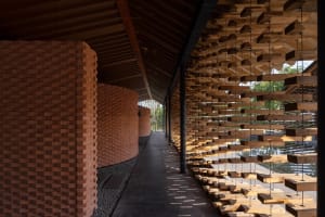 Modern corridor with wood slats and brick walls