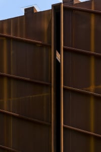 Rustic metal fence with concrete enclosure