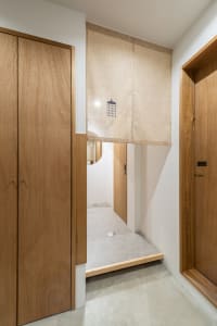 A wooden entry way with a minimalist design and a metallic gray floor.