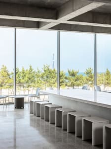Industrial interior with concrete floors and stools.