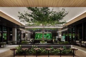 Modern coffee shop interior with indoor plants, wooden counters, and seating.