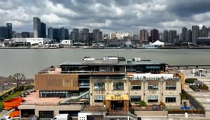 Modern cityscape featuring waterfront buildings and tall skyscrapers.