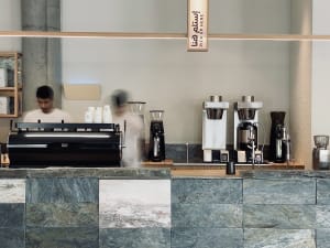 Marble coffee shop counter with espresso machines and cups