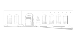 Modern retail storefront with concrete facade and large arched windows.