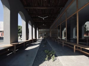 Modern patio with concrete floor and wooden benches
