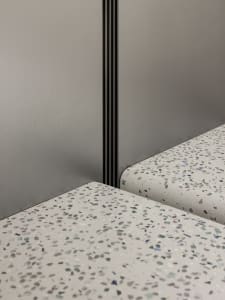 Modern interior design featuring a display of terrazzo floor tiles.