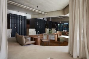 Modern restaurant interior with concrete and wooden elements.
