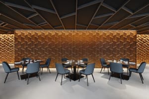 A modern restaurant interior with wooden walls, fabric chairs, and tables.