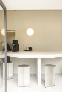 White concrete kitchen with minimalist design and functional features.