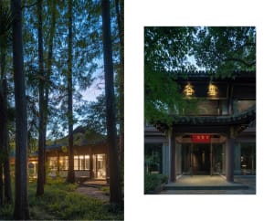 Traditional palace with wooden columns and glass windows surrounded by lush greenery and trees