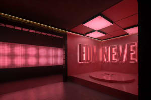 A modern, industrial-themed entertainment venue with illuminated signage and metallic elements.
