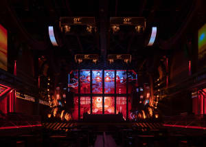 An industrial-style stage with metallic elements and lighting.