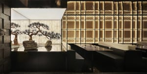 Modern restaurant interior with metallic wall panels and seating areas