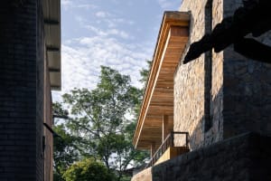 An exterior of a building with stucco and wooden features.