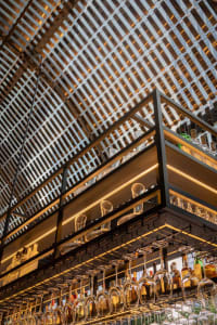 Modern bar interior featuring metal and glass counter structure