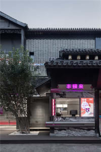 Modern storefront with metal-clad wall and concrete floor tiles