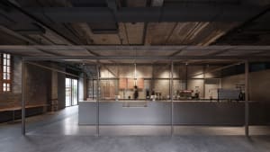 Concrete coffee shop counter with industrial design elements.