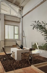 Industrial-style workspace with brick fireplace and glass enclosure